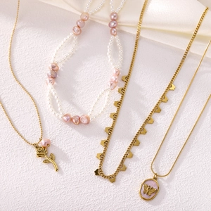 Vintage gold necklaces set with pink pearls, rose pendant and butterfly charms for women