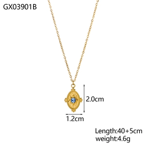 Detail of gold oval pendant with round blue gemstone and starburst texture engraving