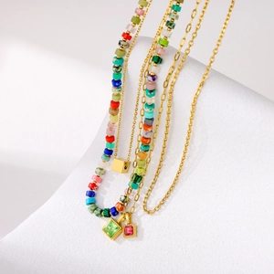 Colorful retro beaded necklace stack with vibrant gemstones on gold layered chains