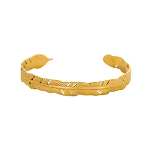 Detailed view of golden feather cuff bracelet with intricate textured metallic patterns