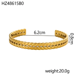 Detail shot of golden C-shaped open cuff with wheat texture, 0.8cm width and 6.2cm diameter