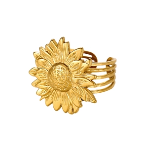 Macro detail of a golden sunflower ring with textured petals and a hollow multi-layer band