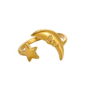 Macro view of gold adjustable ring featuring star and moon charms with logo engraving