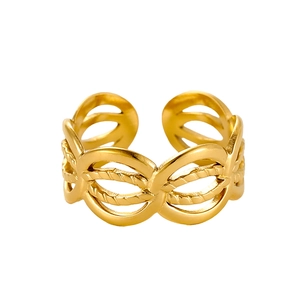 Macro shot of gold adjustable ring featuring oval cutout and woven rope texture detail