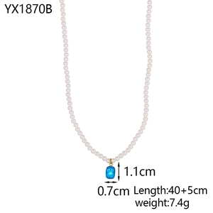 Detail of pearl necklace with blue gemstone pendant showing 40+5cm length measurements