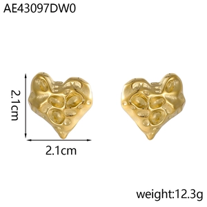 Detail of gold hammered heart stud earrings with irregular vintage texture finish