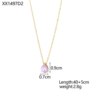 Macro detail of pear-shaped pink zircon pendant with gold claw setting on a slim chain