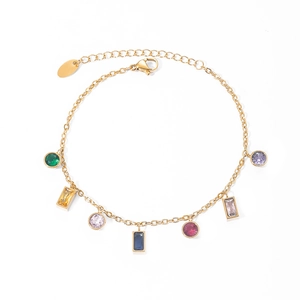 Detail of a gold bracelet featuring multi-colored geometric gemstone charms on white backdrop