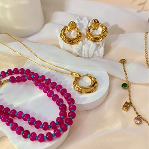 Retro style jewelry set with red and blue beaded necklace and gold plated earrings