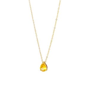 Macro shot of 18K gold plated necklace featuring a pear-cut yellow crystal pendant