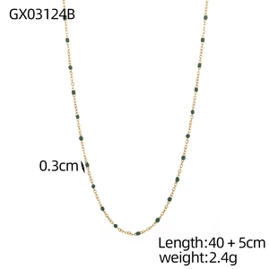 Detail view of dainty gold chain necklace with 0.3cm green stone beads, 40+5cm length