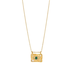 Detailed macro shot of vintage gold hammered rectangular pendant with green evil eye stone