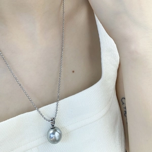 French luxury style pearl pendant necklace featuring a large gray bead on a silver ball chain