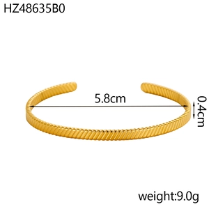 Detail view of gold C-shaped cuff bracelet with size specs and weight of 9.0g