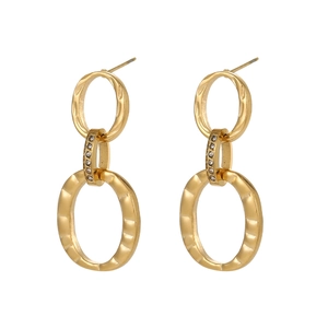 Detail of gold tiered drop earrings featuring textured hammer finish and zircon circles