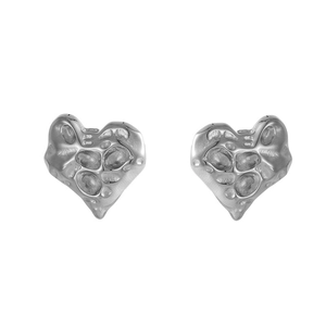 Macro detail of silver heart stud earrings featuring irregular hammered lava texture