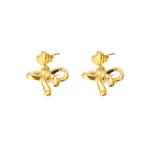 Detail of gold heart earrings with ribbon bow pendant in polished metallic finish