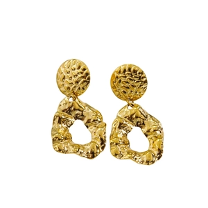 Detailed view of vintage gold earrings with hammered metal texture and irregular hoop