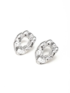 Close-up of silver hammered texture on organic irregular oval drop earrings