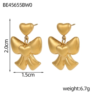 Detailed size view of gold bow and heart earrings showing 2.0cm height and 1.5cm width