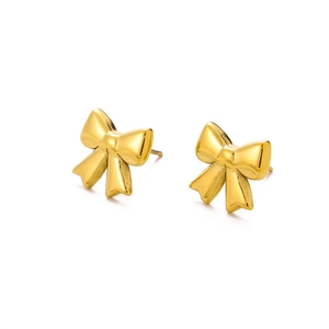 Detailed close-up of golden bow-shaped stud earrings with polished metallic luster finish