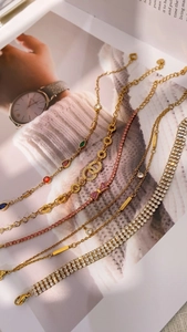 Detailed collection of gold finish bracelets featuring colorful gemstones and crystal pave designs
