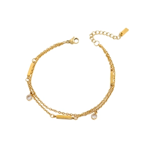Close-up of double-layered gold chain bracelet with round crystals and metallic bars