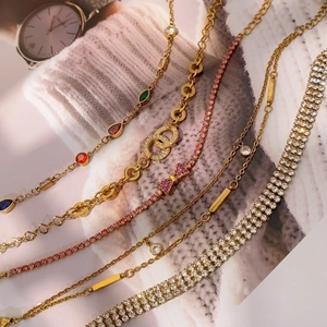 Five assorted gold adjustable bracelets with colorful gemstones and pavé zircon details