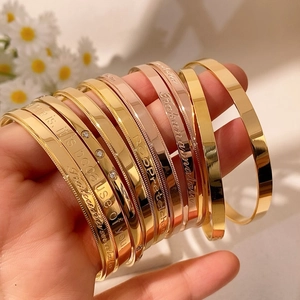 Elegant gold and rose gold bangles with emotional engraving and sparkling stones