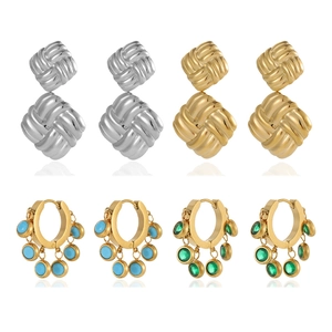 Detail of colorful geometric drop earrings with gold texture and turquoise pendants