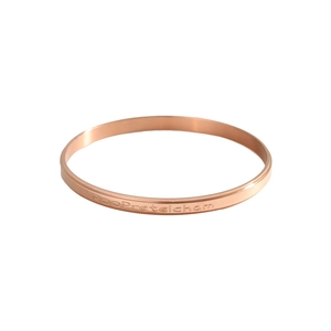 Macro detail of rose gold bracelet with Roopretelcham engraving and milgrain edges