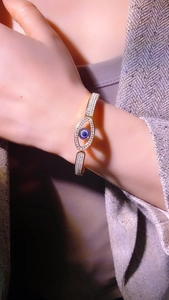 Detail of golden Evil Eye spring bracelet with sparkling pavé zircon stones on wrist