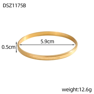Detail view of golden bangle with Hakuna Matata engraving and 5.9cm diameter size