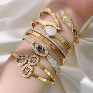 Adjustable gold-plated snake and evil eye bangle bracelets with sparkling rhinestones