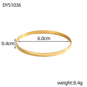 Detail view of gold bangle with Hakuna Matata engraving and 6.0cm inner diameter size