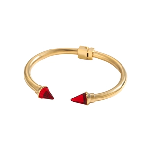 Dettaglio macro dei coni rossi e cerniera in oro lucido su un bracciale aperti