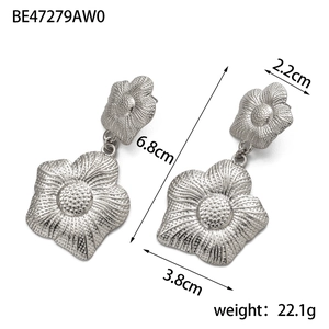 Macro view of silver floral earrings with embossed texture and size 6.8cm measurements