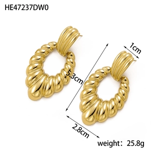 Detail shot of vintage gold oval hoop earrings with radial texture showing dimensions