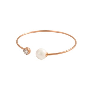 Dettaglio di un bracciale rigido oro rosa con perla bianca e zircone brillante incastonato