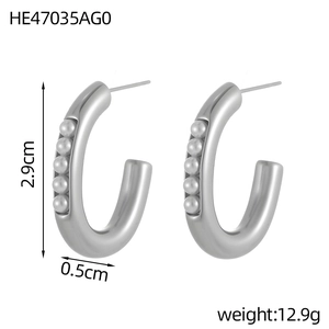 Detail view of silver C-shaped hoop earrings featuring five small white inlaid pearls
