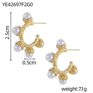 Detailed view of C-shaped gold pearl earrings with dimensions and textured metal