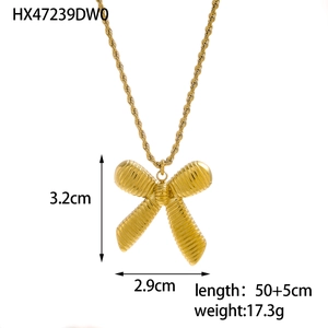 Detailed view of golden bow pendant with textured finish and twisted chain measurements