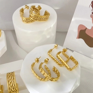 Exaggerated golden earring set with multi-layer braided textures and vintage design