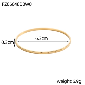 Macro-opname van 0,3 cm gouden gehamerde armband met getoonde afmetingen en textuur