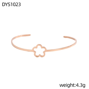 Primer plano de un brazalete de oro rosa con detalle de flor hueca geométrica