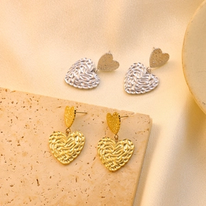 Textured gold and silver heart-shaped drop earrings with vintage ripple surface on stone