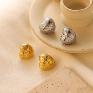 Textured gold and silver heart stud earrings with geometric crinkle finish in a set