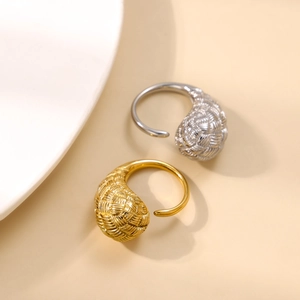 Macro shot of gold and silver spiral woven texture open rings with elegant metallic finish