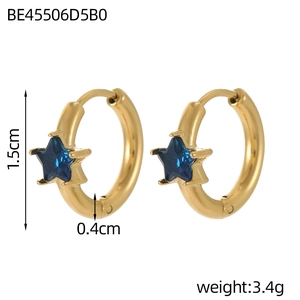 Detail view of small gold hoop earrings featuring a 1.5cm diameter and blue star gemstone