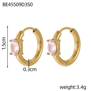 Detail view of gold hoop earrings with pink oval zircon and four-prong setting